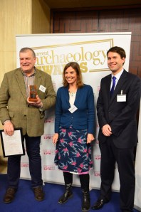 Richard Buckley (left) receives his award from Dr Denise Allen of Andante Travels (middle) and Matt Symonds, editor of Current Archaeology (right).