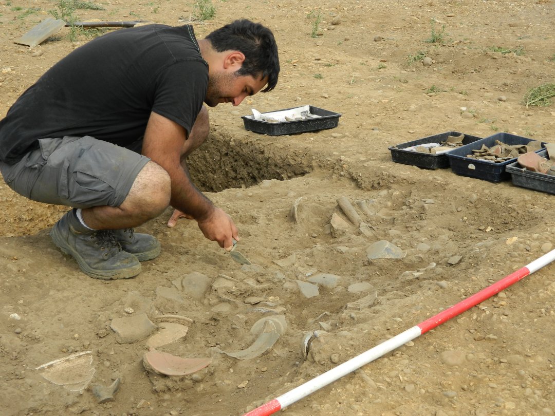 Excavating a deposit of Roman pottery.