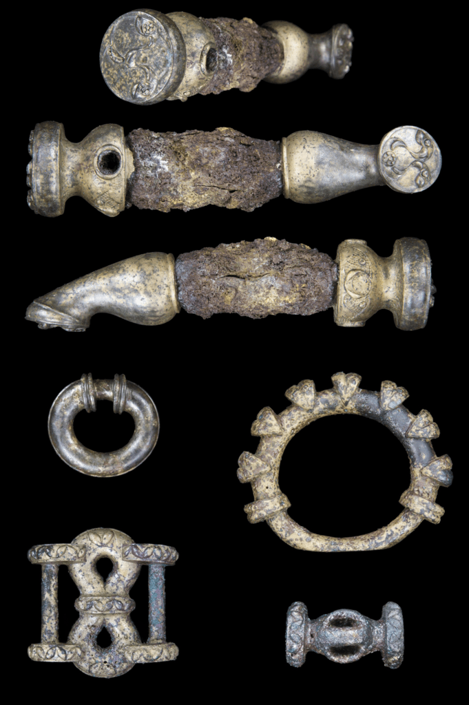 Top: Three views of one of the lynch pins from the Burrough Hill hoard, showing the detail of the decoration. Below: Terret rings and harness gear from the hoard. Image: ULAS